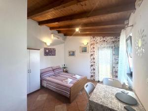 a bedroom with a bed and a table and chairs at Apartments Silvi in Medulin