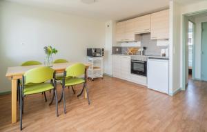 a kitchen and dining room with a table and chairs at Centre Jean XXIII in Annecy