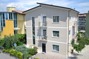 an apartment building with balconies on a city street at Le Bouganville Apartment in Desenzano del Garda