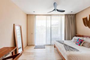 a bedroom with a bed and a large window at Xaana Private Pool 2 bed wifi 300 Mbps Rooftop in Tulum +32 photos