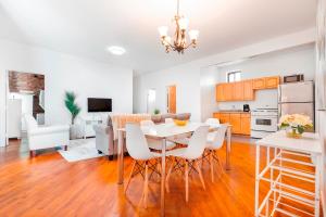 a kitchen and dining room with a table and chairs at Prime Location Upper Manhattan Furnished Apartment in New York