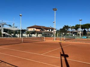 a tennis court with a shadow of a tennis net at Casa Flo' in Marina di Carrara