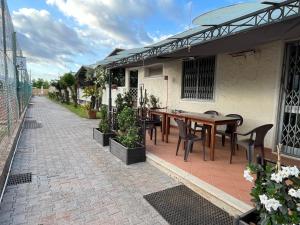 an outdoor patio with a wooden table and chairs at Casa Flo' in Marina di Carrara