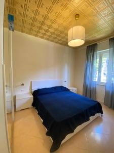 a bedroom with a blue bed and a ceiling at Residenza Minori in Minori