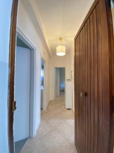 a hallway with a wooden door in a room at Residenza Minori in Minori