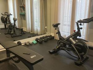 a gym with several exercise bikes and a mirror at 5 On Dana in Gqeberha