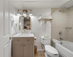 a bathroom with a sink toilet and a mirror at Bella Vista Suites Lake Geneva in Lake Geneva +23 photos