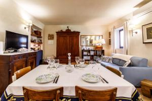 a dining room with a table and a couch at Appartamento Holly House in Radda in Chianti