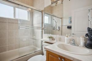a bathroom with a sink and a shower and a toilet at Bright and Comfy 3BR Home Ideal for Families in Vancouver +13 photos