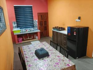 a kitchen with a table with a bag on it at AF Homestay in Bachok