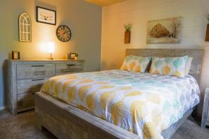 a bedroom with a bed and a dresser and a clock at The Greens at Thousand Hills in Branson +24 photos