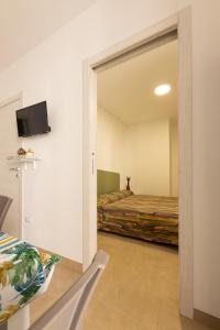 a bedroom with a bed and a sliding glass door at Centonze appartamenti in San Foca