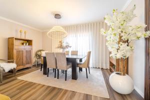 a dining room with a black table and chairs at Maria Home Reall's in Braga