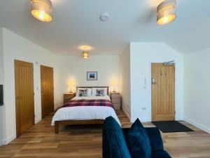 a bedroom with a bed and a couch at Viewforth Studio No.4 in Fort William