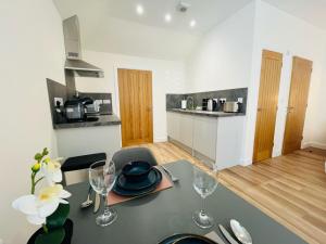 a kitchen with a table with wine glasses on it at Viewforth Studio No.4 in Fort William