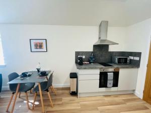 a kitchen with a table and a stove top oven at Viewforth Studio No.4 in Fort William