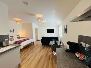 a hotel room with a bed and a kitchen and a living room at Viewforth Studio No.4 in Fort William