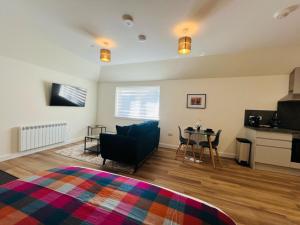 a living room with a couch and a table at Viewforth Studio No.4 in Fort William