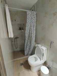 a bathroom with a toilet and a shower at Iliana's Cozy Home in Arta +10 photos