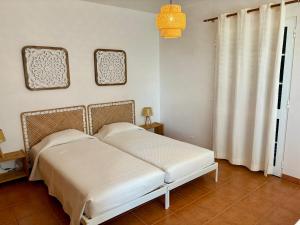 Postel nebo postele na pokoji v ubytování Oliveira's Home