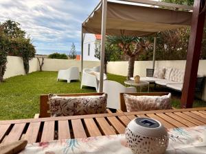 a patio with a table and chairs and an umbrella at Oliveira's Home in Porto Santo
