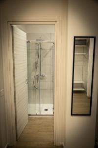 a bathroom with a shower with a glass door at Chez Nunù in Ercolano +45 photos
