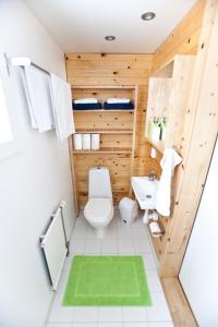 a bathroom with a toilet and a sink at Wildact Adventure AB in Storberg
