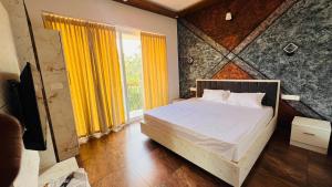 a bedroom with a bed and a window with yellow curtains at Wayanad Haven Villa in Wayanad