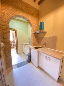 a kitchen with a sink and a counter top at Apartamentos Abeto in Ronda +38 photos