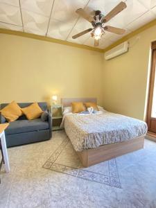 a bedroom with a bed and a couch at Apartamentos Abeto in Ronda