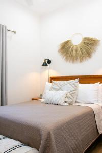 a bedroom with a large bed with white pillows at Casa Baja - Depa completo 2 recámaras in Loreto