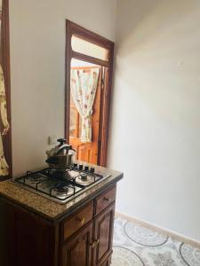 a kitchen with a stove with a pot on it at Casa Farah 2 in Chefchaouen +8 photos