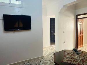 a living room with a flat screen tv on a wall at Casa Farah 2 in Chefchaouen
