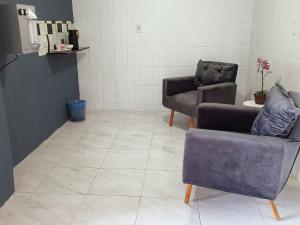a living room with two chairs and a couch at NORTE HOTEL Guaraciaba in Guaraciaba do Norte