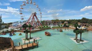 an amusement park with a ferris wheel in the water at Mobile Home LOREN in Biograd na Moru