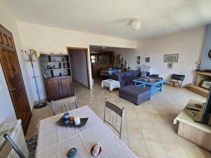 a living room with a couch and a table at Booklou Apartment in Ancient Epidauros
