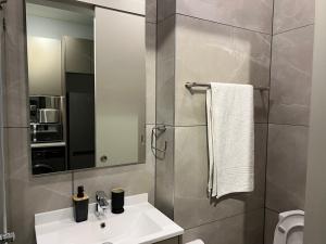 a bathroom with a sink and a mirror at One Rosebank in Johannesburg