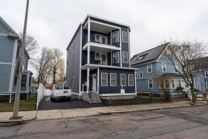 a blue house with a white van parked in front of it at 558-3 3BR Boston - Modern Nest near Franklin Park in Boston