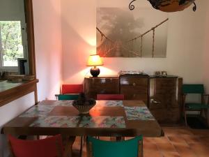 a dining room with a wooden table and chairs at villa chêne liège in Moliets-et-Maa