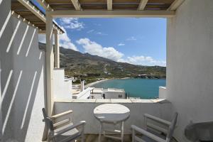 a balcony with a table and chairs and a view of the water at The Goat House by Tinosstay in Kardhianí
