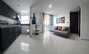 a kitchen and a living room with a couch in it at EXCELENTE CONJUNTO, UBICACION PRIVILEGIADA, Torre 3 in Armenia