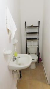 a bathroom with a white sink and a toilet at Comfortable and Centrally Located Accommodation 2 in Altamira