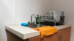 a kitchen sink with an orange towel on the counter at Comfortable and Centrally Located Accommodation 2 in Altamira +8 photos