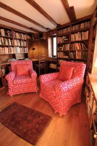 a living room with two chairs and bookshelves at Chalet Broski - Luxury near St Martin De Bellville in Planvillard