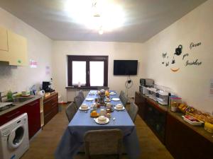a kitchen with a blue table with food on it at B & B La Mela in Darfo
