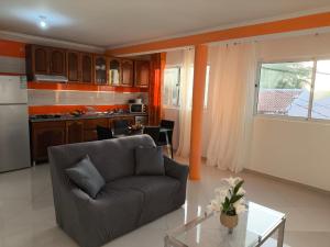 a living room with a couch and a kitchen at Catedral View Apartment in Cidade Velha