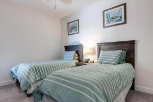 two beds sitting next to each other in a bedroom at Stunning waterfront 3 BR condo with amazing views - A Wave from it all in Bradenton +33 photos