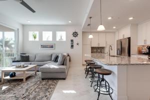 a kitchen and living room with a couch and a table at Stunning waterfront 3 BR condo with amazing views - A Wave from it all in Bradenton