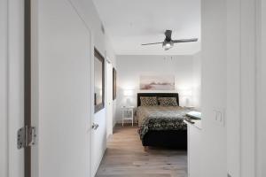 a bedroom with a bed and a ceiling fan at Luxury Condo Living on Sarasota Bay, Minutes From Downtown in Sarasota +52 photos