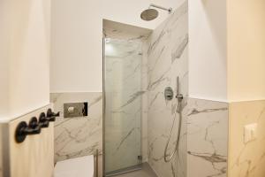 a bathroom with a shower with a glass door at Casa di borgo in Rome